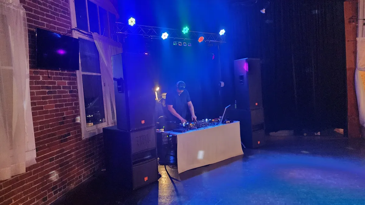 DJ performing with full stage lighting